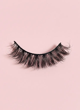 Pair of false eyelashes on a pink background
