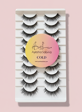 Set of false eyelashes in a packaging with 'Ayesha Sabina' branding on a pink background
