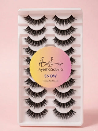 Set of false eyelashes in a packaging tray with 'Ayesha Sabina' branding on a pink background.