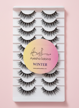 Set of false eyelashes in a packaging box with 'Ayesha Sabina' branding on a pink background.