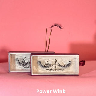 Eyelash packaging with 'Ayesha Sabina' branding on a pink background