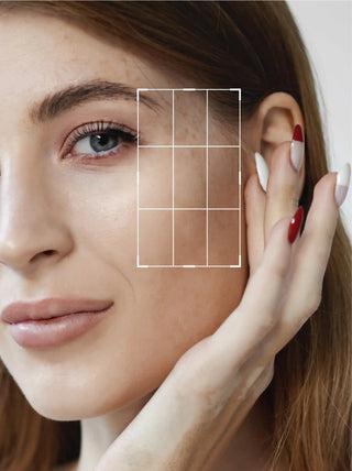 Close-up of a woman's face with a focus on her ear and hand, highlighting skin texture.
