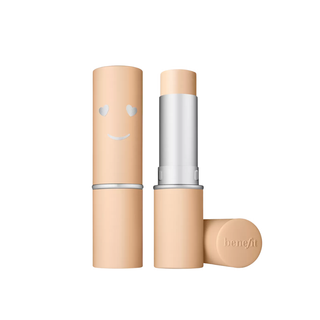Benefit makeup stick with smiley face design on cap against white background