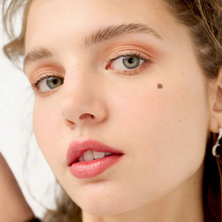 Close-up of a woman's face with a neutral background