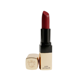 Lipstick with gold casing and black cap on a white background