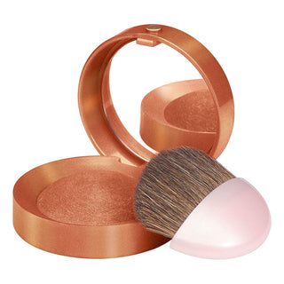 Bronze compact powder with a brush on a white background