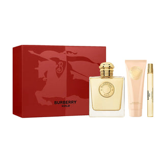 Burberry Gold perfume set with red box, gold bottle, and cream on a white background