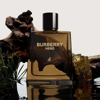 Burberry Hero perfume bottle with natural elements on a reflective surface