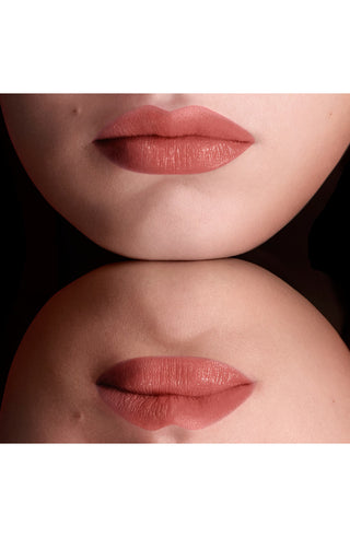 Close-up of a person's lips wearing a matte lipstick on a neutral background