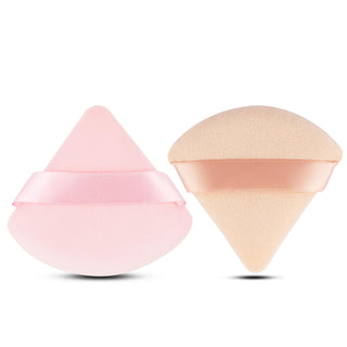 Two cosmetic sponges, one pink and one beige, on a white background