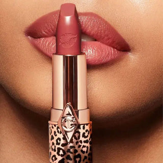 Lipstick with leopard print design applied to lips on a close-up of skin.