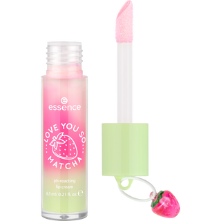 Pink and green lip cream with strawberry charm on a white background