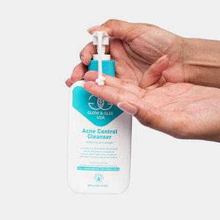 Hand holding a bottle of Acne Control Shampoo with a white background