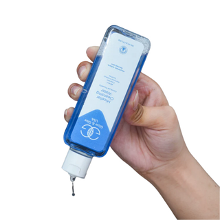 Hand holding a blue bottle with a dropper, on a white background