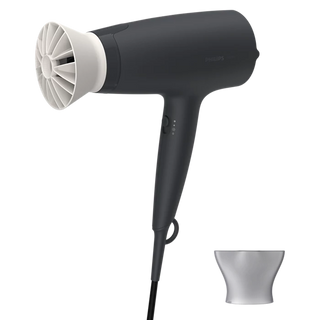 Black hair dryer with white nozzle on a white background