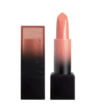 Lipstick with a gradient color and 'HUDA BEAUTY' branding on a white background