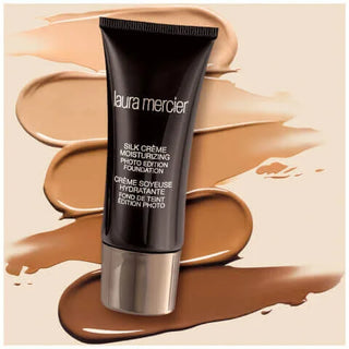Laura Mercier foundation tube with foundation swatches on a beige background