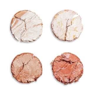 Four round makeup powders in different colors on a white background