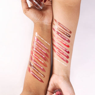 Lipstick swatches on a person's arm with color names written above each swatch.