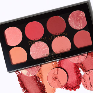 Makeup blush palette with various shades of pink and red, featuring the brand 'Revolution'.