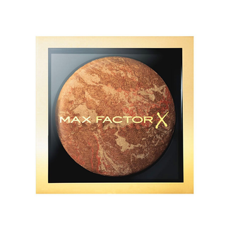 Max Factor bronzer compact with gold frame on a white background