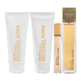 Michael Kors Sexy Amber perfume set with lotion and rollerball on a white background
