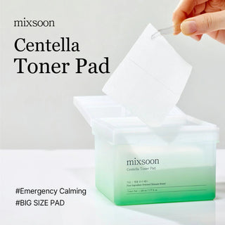 mixsoon Centella Toner Pad packaging with a hand holding a pad against a light gray background