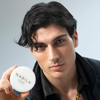 Man holding a white container labeled 'Nabila' against a gray background