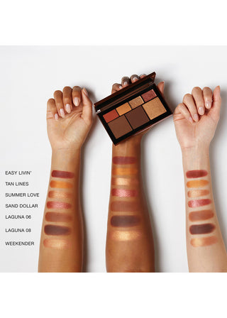Makeup palette with swatches on hands against a white background