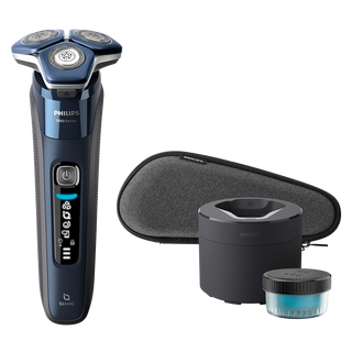 Philips shaver with cleaning container and brush on a white background