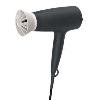 Black hair dryer with white nozzle on a white background