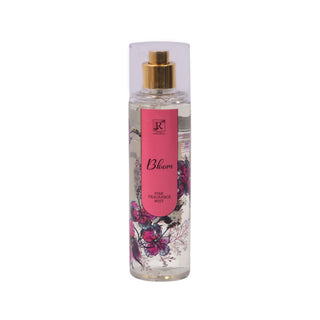 Perfume bottle with floral design and pink label on a white background