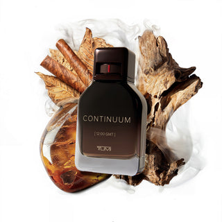 TUMI Continuum perfume bottle with natural elements on a white background