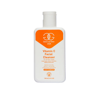 Vitamin C facial cleanser bottle with orange label on a white background