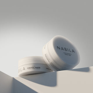 Two jars of NABILA hair products on a light gray background