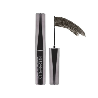 Huda Beauty mascara with wand on a white background