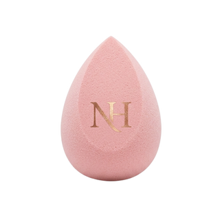 Pink makeup sponge with 'NH' logo on a white background