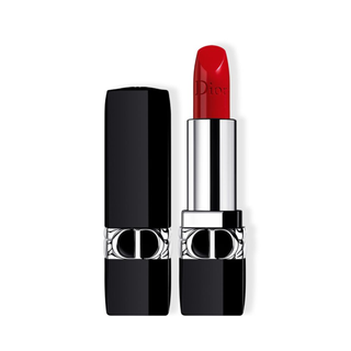 Red lipstick with black and silver Dior case on a white background