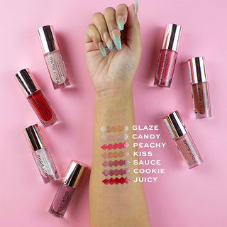 Lip gloss products with swatches on a hand against a pink background